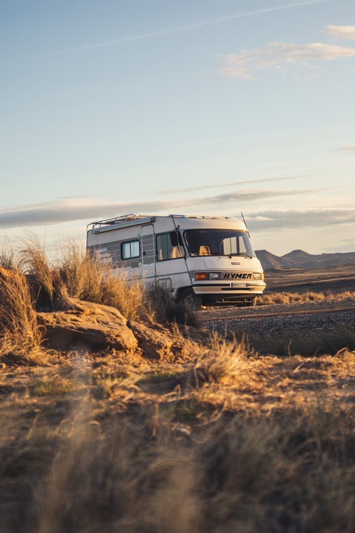 get-in-touch A classic camper van parked in the stark beauty of Bardenas Reales desert, Spain.