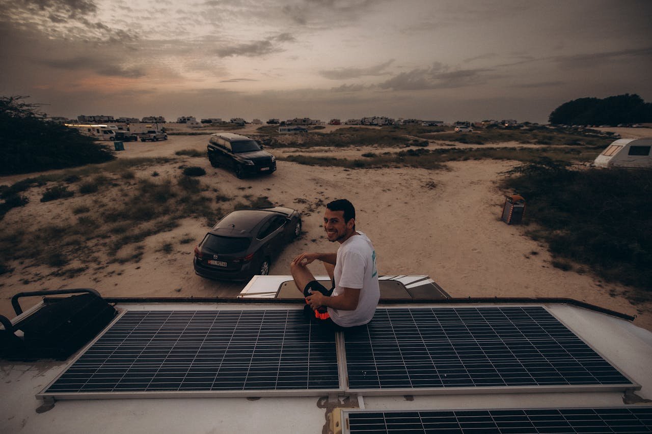Explore the serene desert landscape in Dubai at sunset with camping and solar panels.